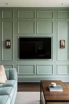 a living room filled with furniture and a flat screen tv mounted on the wall above it