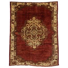 a red rug with an ornate design on it