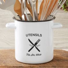 utensils in a white pot with spoons and forks