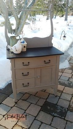 an old dresser is sitting outside in the snow