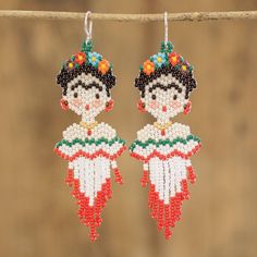 a pair of beaded earrings hanging from a string