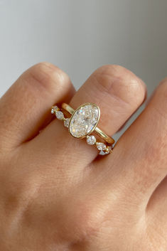 a woman's hand with a gold ring and diamond set on the middle finger