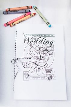 a wedding coloring book with crayons and markers on the table next to it