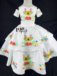 This beautiful dress resembles the escaramuza girls from Mexico. It is also calle charro dress. Is it beautiful, the detail on it is a work of art. All the embroidery is specially designed. I choose this colors because that how the customer wanted, but keep in mind it is made by order. That meant I can customize it however you want. Any color you choose I'll be happy to make it perfect for you. The dress is one piece but I also include a tulle underskirt to make it full but confortable I case th Traditional White Costume Dress, Traditional Wedding Dress For Fiesta, White Dresses For Cinco De Mayo Fiesta, Red Charro Dress, Escaramuza Dresses, Embroidered Ball Gown, Charro Dress, Mexican Theme Party, Tulle Underskirt