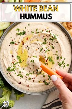 Overheard photo of white bean hummus surrounded by crudites and a hand with a carrot dipping with recipe title block at the top. Dips Appetizers, Best Hummus Recipe, White Bean Hummus, Easy Hummus Recipe, Creamy Hummus, Hummus Ingredients, Hummus Recipe Homemade, Easy Hummus, Homemade Hummus