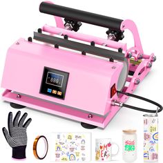 a pink machine that is next to some gloves and other items in front of it