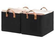 two black storage bins with brown handles and white towels in the top one is open