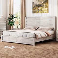 a white bed sitting on top of a wooden floor