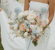 a bride holding a bouquet of flowers in her hands