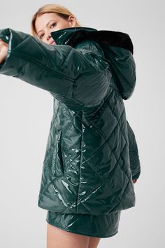 Make a snow day statement in this high-shine puffer jacket. We love the cute quilted finish, the light fill and the wide silhouette that leaves room for layering. Details like elbow patches, a cargo pocket on the arm and a faux-fur-lined hood finish it all off. Wear it with a matching set to walk to your workout or pair with the complementary skirt for a perfect après look. Alo Yoga Long Sleeve Puffer Jacket For Fall, Green Quilted Winter Jacket, Trendy Nylon Quilted Outerwear, Trendy Quilted Nylon Outerwear, Alo Yoga Winter Puffer Jacket, Alo Yoga Long Sleeve Winter Puffer Jacket, Alo Yoga Winter Outdoor Outerwear, Trendy Quilted Nylon Puffer Jacket, Trendy Quilted Down Outerwear