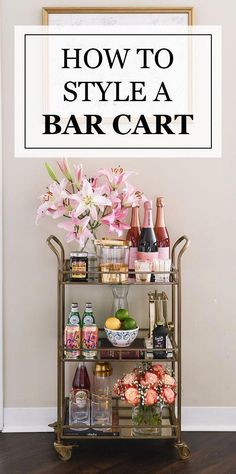 a bar cart with flowers and bottles on it in front of a sign that says how to style a bar cart