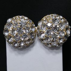 *Description: This is a beautiful pair of Blanca designer dome earrings with large sparkling clear rhinestones in a gold plated circular base. The clips are signed on the back by the designer and were in circulation in the 1980s. These designer runway earrings are gorgeous and full of sparkle. This would be a great addition to your vintage jewelry collection or make a great vintage gift! *Approximate Measurements: Length & Width - 1 3/8 Inches *Condition: Great vintage condition. May see sig Round Rhinestone Clip-on Earrings For Parties, Round Clip-on Rhinestone Earrings For Parties, Round Clip-on Earrings With Rhinestones For Party, Party Clip-on Earrings With Rhinestones, Runway Earrings, Dome Earrings, Formal Earrings, Designer Runway, Vintage Christmas Gifts