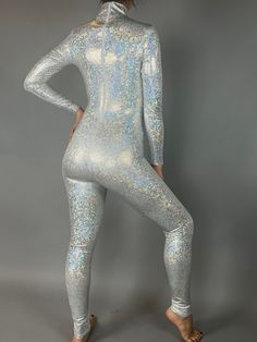 Command the spotlight in our Holographic Silver Catsuit! Designed for dancers, aerialists, and performers, this eye-catching full-body catsuit features a stunning holographic, broken glass design. With a turtleneck, long sleeves, and a convenient back zipper, this silver catsuit offers both style and functionality. Mesmerizing Shine: The holographic effect creates a dazzling, reflective appearance that catches the light as you move. Secure Fit: The snug fit and stretchy fabric ensures comfort an Exotic Dance, Jumpsuit For Women, Fits Women, Broken Glass, Color Fabric, Catsuit, Trending Now, Dance Wear, Full Sleeve