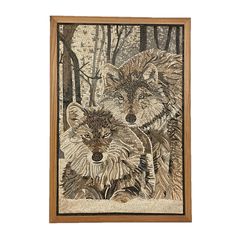 two wolfs in the woods are depicted on a white wall with wood framed artwork