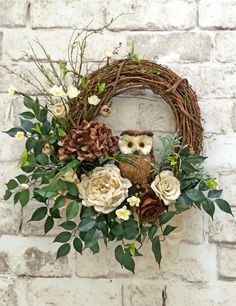 a wreath with an owl sitting on top of it