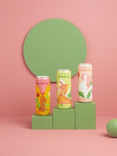 three different types of cans sitting on top of a green block next to an egg