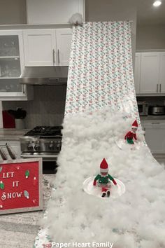 a christmas tree made out of fake snow in a kitchen with a sign saying let it snow