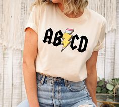 Teacher Shirts Kindergarten, Cute Preschool Teacher Shirts, Abcd Teacher Shirt, Teacher Design Shirts, Teacher Outfits For Hot Weather, Teacher Shirts Cricut, Teacher Graphic Tees, Preschool Shirts For Teachers, Cricut Teacher Shirts