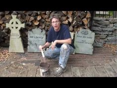 a man sitting on the ground with a paint can in front of some tombstones