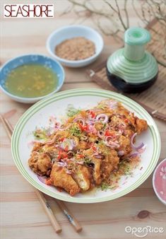 there is a plate with some food on it and two bowls next to the plates