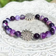 Handmade - This Gorgeous Bracelet Is Made With Smooth Round Purple Agate Beads. The Agate Beads Have Unique Stripes, Patterns, And Hues Of Purple Created By The Minerals That Grew With The Agate In Nature. Large Silver Beads In The Shape Of A Shining Sun Accent The Striped Gemstones. The Two Silver Focals Feature An Etched Celestial Pattern On Both Sides. The Bracelet Is Double Strung For Durability, Stretches For Comfort, And Stacks Well With Other Accessories. Agate Is A Calm Stone That Foster Amythest Bracelet, Future Christmas, Earth Connection, Celestial Pattern, Purple Agate, Bracelets Handmade Beaded, Bead Stringing, Gorgeous Bracelet, Agate Beads