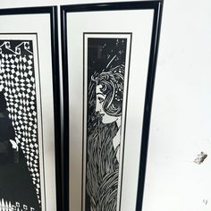 two black and white framed art pieces on the wall next to each other, one with a woman's face