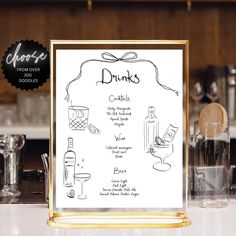 the menu for drinks is displayed in front of some glasses and other items on the counter