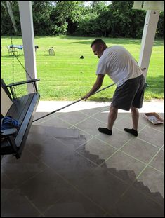 a man is cleaning the porch with a mop