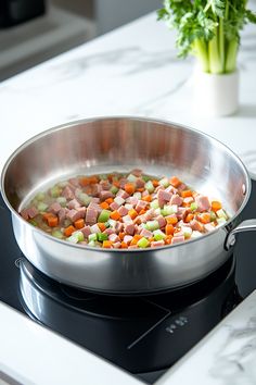 a pan filled with vegetables sitting on top of a stove