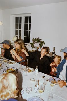 a group of people sitting around a dinner table