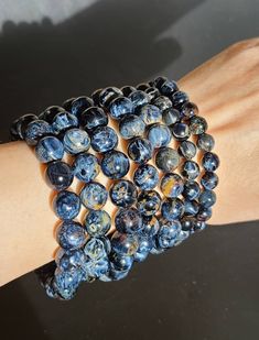 "Mysterious and mystical, these gemmy pietersites bracelets have strong flashes of blue, black and gold colors. Pietersite is a very protective crystal. These bracelets fits 6 1/2\" to 8\" wrist. Options: Option 1 - 6 about 7mm - 8mm Option 7 -  18 about 8mm - 10mm Please note, these are natural crystals with lots of surface marks or chips or pits which adds to the character of the crystal. We do our best to capture them in the photo, but they may not show up properly. Please contact us prior to your purchase if you require more pictures. Please select your preferred options under the variations menu and add to your cart. Orders are processed and shipped in 2 to 4 business days. Please see our Shop Policies for details on shipping delivery times. Shipping upgrades are available at the time Spiritual Sapphire Beaded Hand-strung Bracelet, Hand-strung Sapphire Beaded Bracelets, Spiritual Sapphire Hand-strung Beaded Bracelets, Spiritual Sapphire Beaded Bracelets Hand-strung, Essential Oil Holder, Meditation Beads, Third Eye Chakra, Chakra Crystals, Third Eye