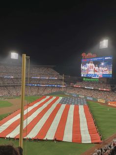 an american flag is displayed on the field at a baseball game