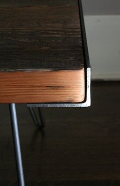 a wooden table with metal legs on it