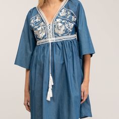 Boho-chic style with a modern accent. This denim mini dress features a spectacular embroidery detail in the chest, as well as romantic oversize french sleeves  and tassels to add more charm to this beautiful dress. Got any cowboy boots? It will be the perfect match! 100% Cotton. Wash Machine  30º ,  Press Medium  Temperature, Do  not  use spin-dry, Do not Bleach Bohemian Denim Dresses For Spring, Spring Bohemian Denim Dress, Embroidered Long Sleeve Denim Summer Dress, Chic Embroidered Cotton Mini Dress, Spring V-neck Dress With Embroidered Sleeves, Chic Cotton Mini Dress With Floral Embroidery, Chic Floral Embroidery Cotton Mini Dress, Bohemian Embroidered Denim Dress, Bohemian Denim Dress With Floral Embroidery For Spring