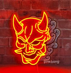 a red neon sign with an image of a demon head on it's face