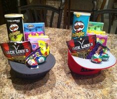 two hats sitting on top of a table filled with snacks and candy bar wrappers