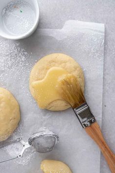 the dough is being spread with a whisk