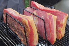 three pieces of meat sitting on top of a grill