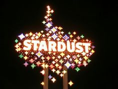 the stardust sign is lit up at night