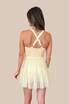 The cutest activewear dress that's fashionable and functional for everything from running errands, to dance, pickleball, running, tennis and more! The Popflex Corset Pirouette Dress in Buttercream yellow features incredibly soft fabric, a scoop neckline, an outer tulle skirt with shorts underneath featuring side pockets. This item is excluded from some discounts. *Authorized Popflex retailer* Becca is 5'5", Bust 33", Waist 25", Hips 33" wearing a size XX-Small. Fitted Tennis Dress With Built-in Bra For Spring, Fitted Tennis Dress With Built-in Bra For Summer, Stretch Nylon Mini Dress For Summer, Summer Nylon Stretch Mini Dress, Summer Stretch Nylon Mini Dress, Mini Length Tennis Dress With Built-in Bra For Workout, Summer Stretch Nylon Dresses, Fitted Tennis Dress For Gym In Spring, Fitted Tennis Dress For Summer Workouts