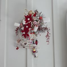 a white door decorated with red and silver decorations