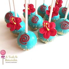 blue cake pops with red flowers on them