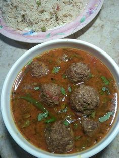 two bowls filled with meatballs and rice