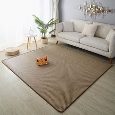 a living room with a couch, chair and rug