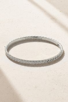 David Yurman updates its signature 'Cable' design, carving the wavy motif into this 18-karat white gold bangle to create the illusion of a chain. Alternate ridges are enhanced by light-reflecting diamonds that highlight the sculpted shape. It's such an easy collection to mix and match - every combination looks effortlessly elegant. Designer White Gold Bracelets With Single Cut Diamonds, Designer White Gold Diamond Bracelet, Designer White Gold Diamond Bangle Bracelet, Designer White Gold Diamond Jubilee Bracelet, Designer White Gold Bangle With Jubilee Bracelet, Platinum Diamond Cut Bangle, Elegant Platinum Bangle With Single Cut Diamonds, Luxury White Diamond Cut Bangle, Elegant Engraved Sterling Silver Bracelet In White Gold