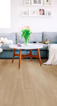 a living room filled with furniture and flowers