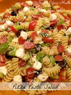 a pizza pasta salad is shown in an orange bowl