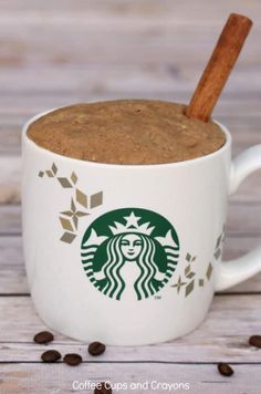 a close up of a cup of coffee with a cinnamon stick in it