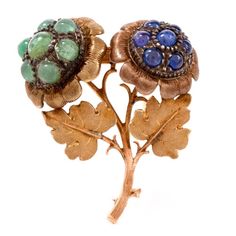 his artfully designed and meticulously crafted pin brooch with unsurpassed antique flair is an authentic work of the Italian designer Buccellati, rendered in 18-karat yellow gold, weighing 21.6 grams and measuring 45 mm x 40 mm. This early vintage pin brooch depicts a pair of flowers on stem with two botanically accurate leaves on both sides of the stem. Each flowers are adorned with 7 emerald and 7 sapphire round cabochons respectively, each assembly surrounded by gracefully scalloped gold 'pet Buccellati Jewelry, Haute Jewelry, Artfully Designed, Austro Hungarian, Floral Pins, Floral Squares, Antique Brooches, Gold Picture Frames, Enamel Brooch