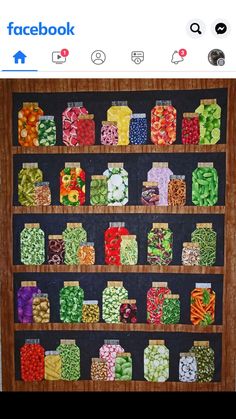 a wooden shelf filled with lots of different types of candy on top of each other